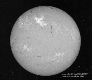 A view of the Sun on May 23, 1967, in a narrow visible wavelength of light called Hydrogen-alpha. The bright region in the top center region of brightness shows the area where the large flare occurred. Image: National Solar Observatory